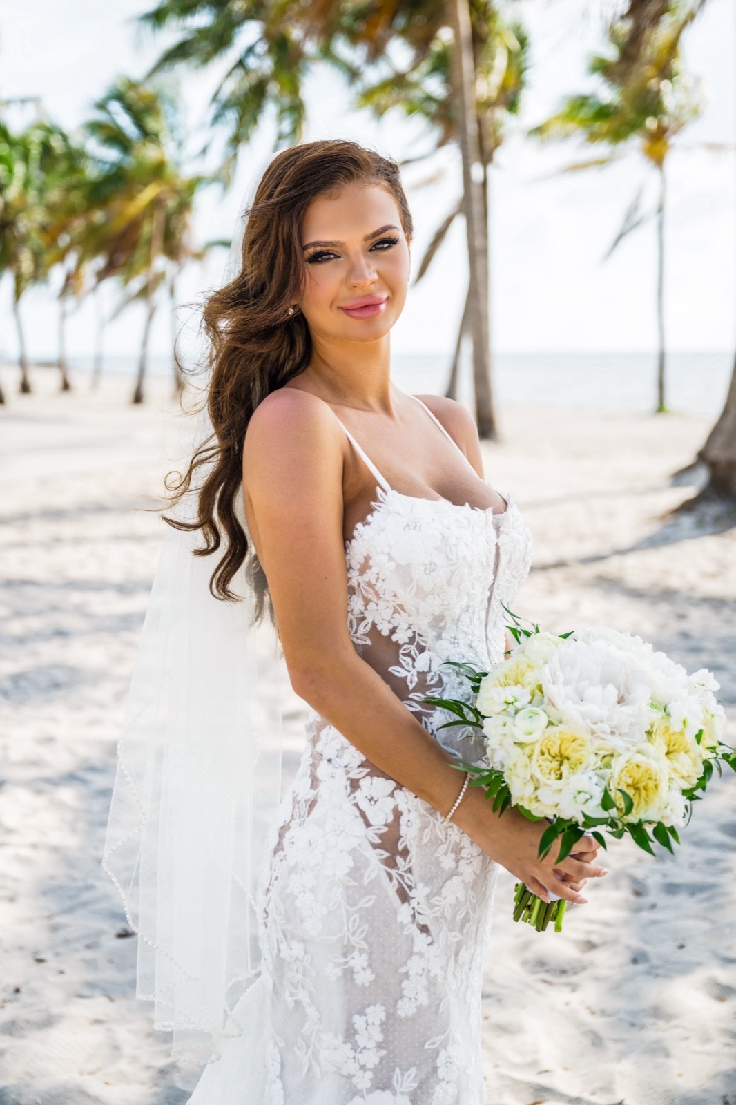 Bride in her wedding dress with a natural Sunkiss Studios bridal spray tan on her Miami wedding day